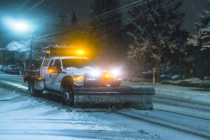 Snow plow truck at night